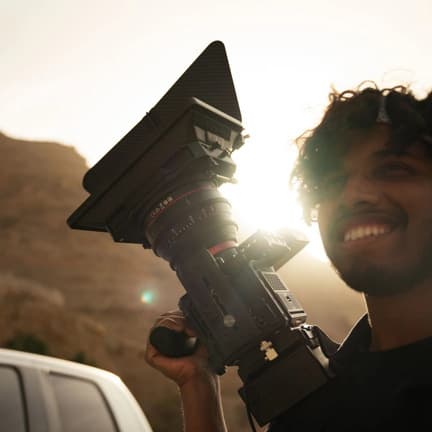Hayden Dias working with a cinema camera outdoors